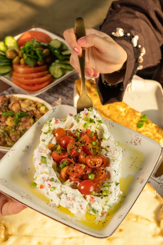 fresh labneh topped with tomatoes at ghusoun lebanese restaurant